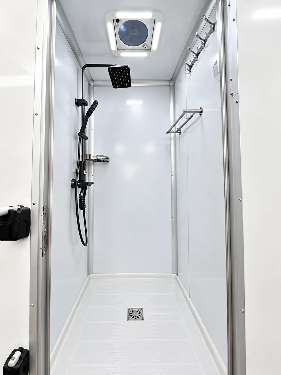 Mobile shower trailer wash station in the 20 ft five-stall shower trailer with handwashing sinks