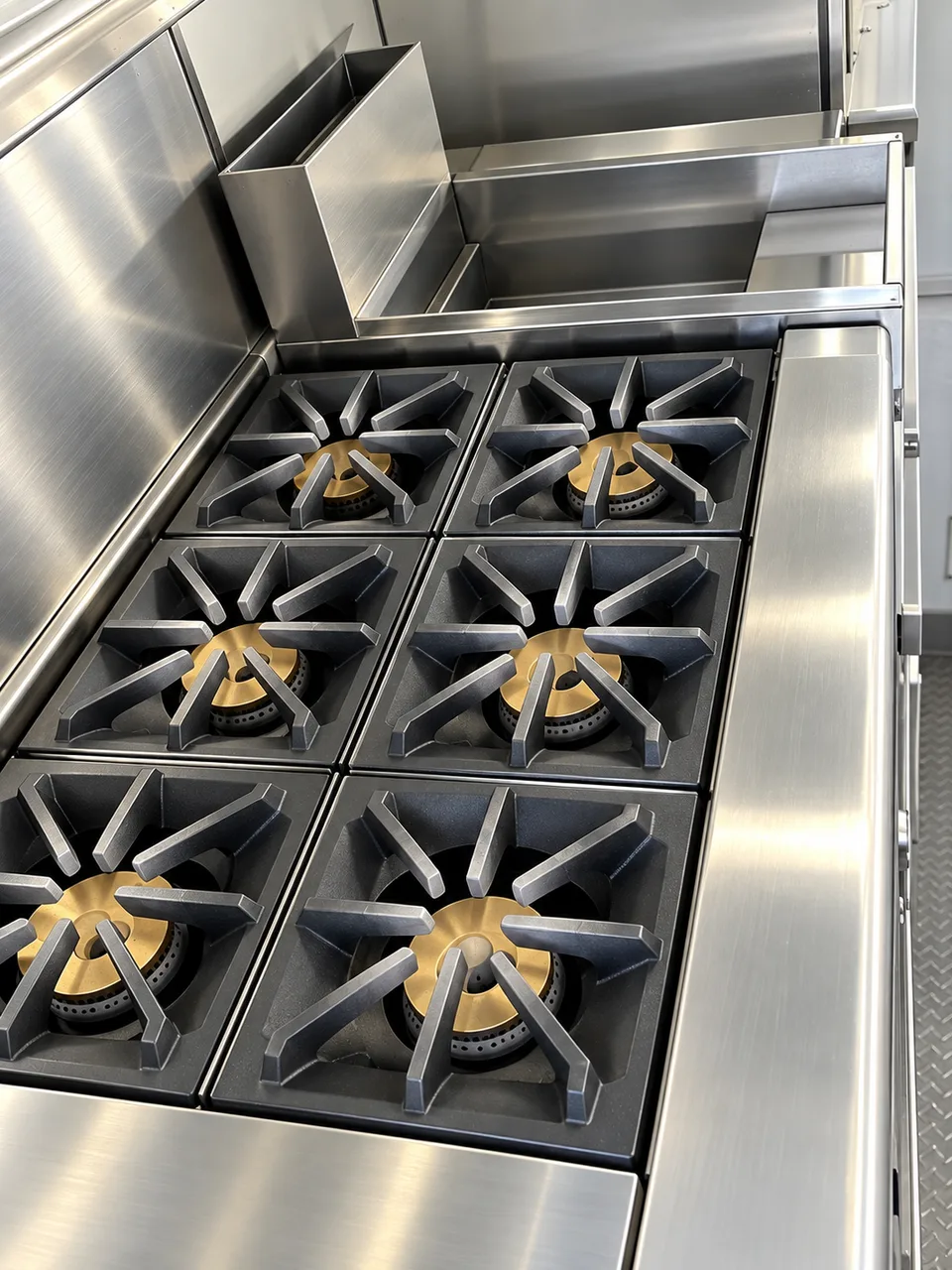 Commercial six burner gas range in the 24 ft mobile kitchen trailer