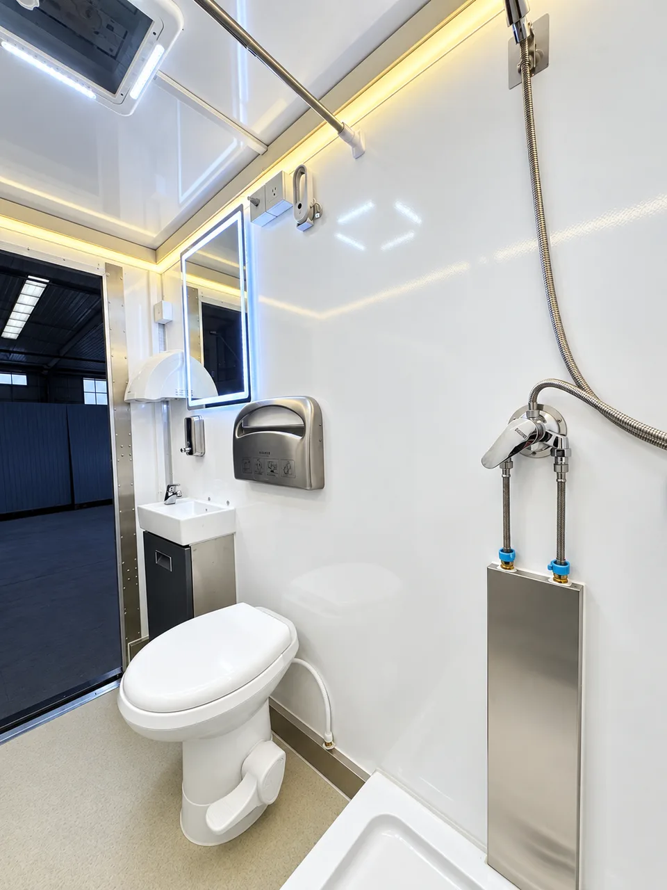 Commercial luxury shower restroom trailer interior in the three-stall shower and restroom combination trailer with one ADA stall